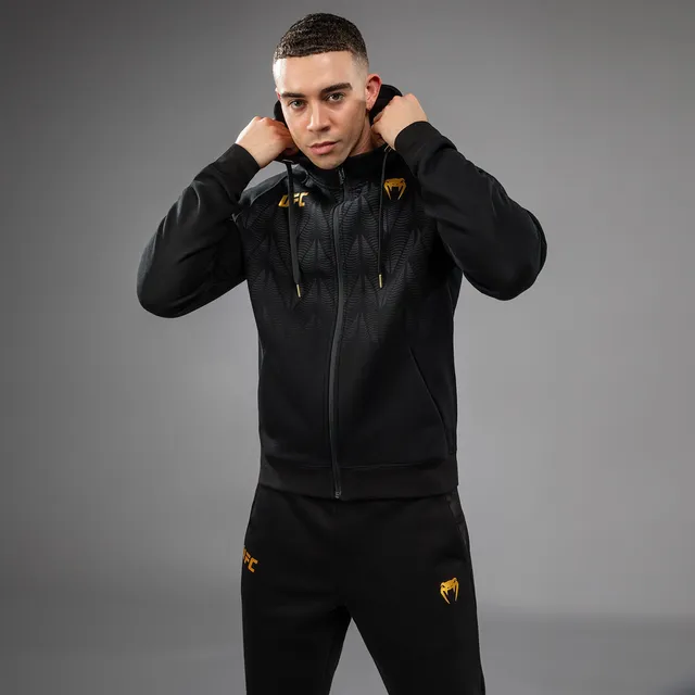 venum-ufc-zenith-replica-zip-hoodie-herren-champion-schwarz-gold image 1