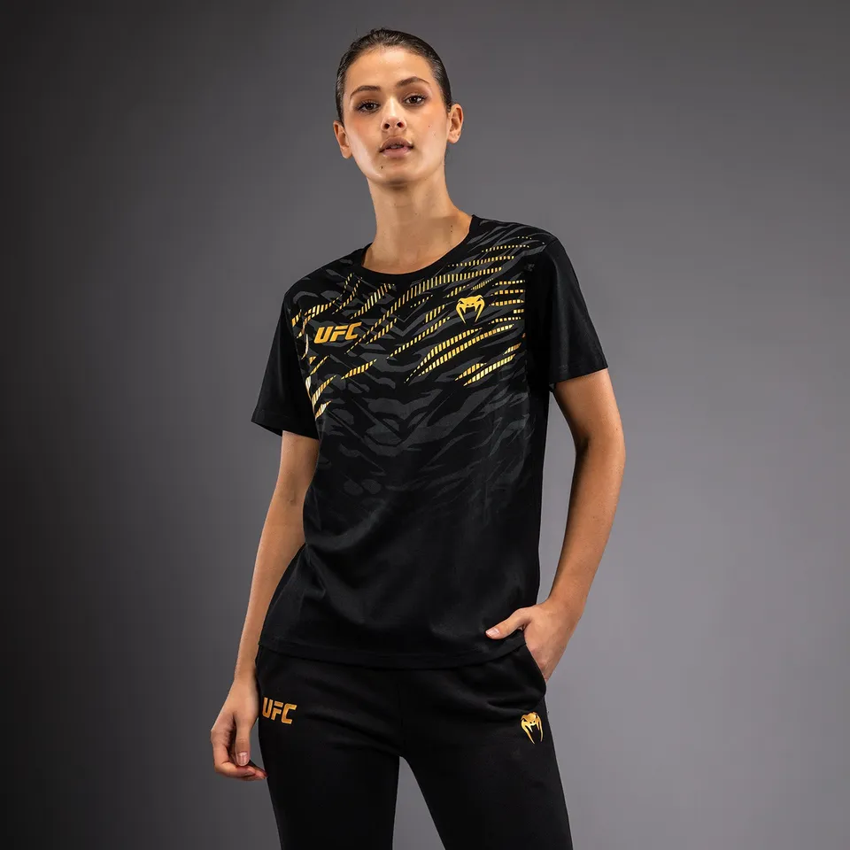 ufc-fusion-by-venum-replica-damen-t-shirt-kurzarm-champion-schwarz-gold image 1